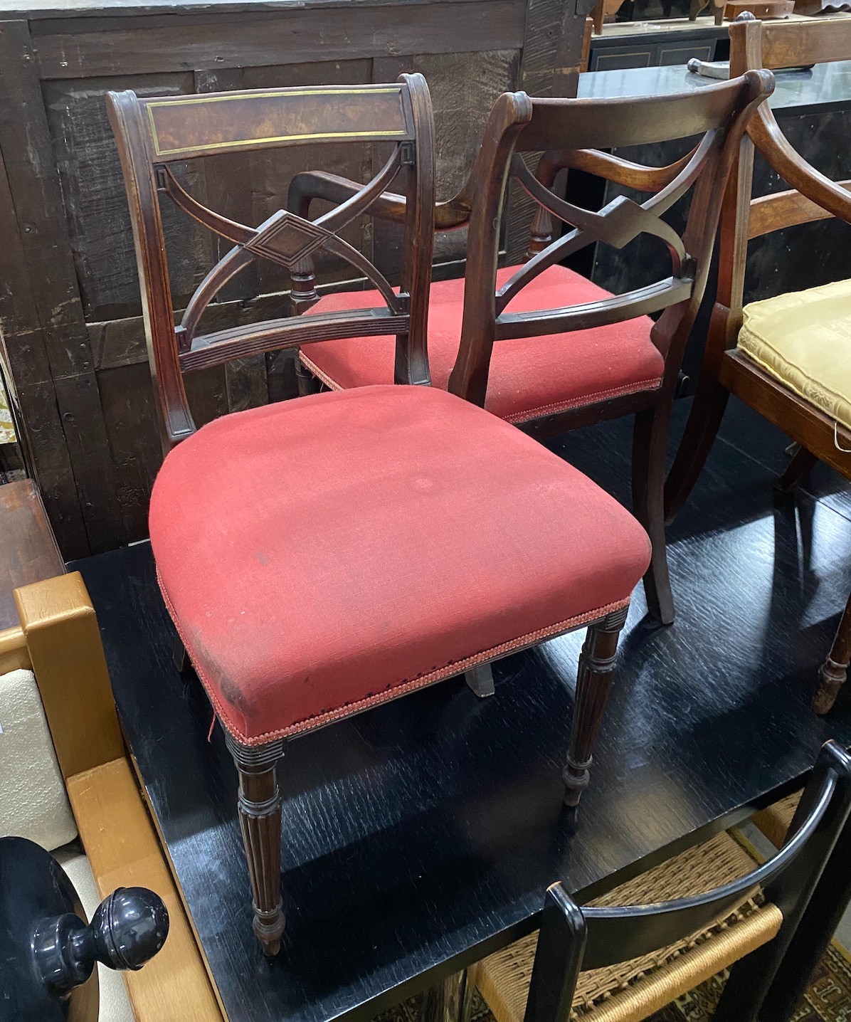 Four Regency brass inlaid mahogany dining chairs one with arms, together with a Regency caned seat elbow chair.